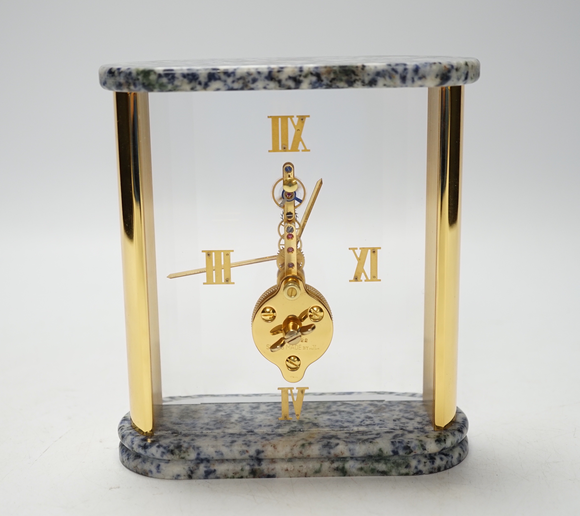 A Jaeger Le Coultre 'Mystery' clock, with gilt Roman numerals and side columns, the top and base of variegated blue marble, 14cm